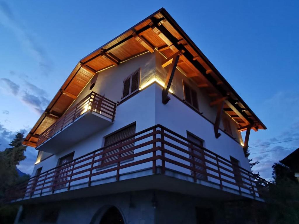 a house with a lit up roof at dusk at Rosso di Sera B & B in Pralungo