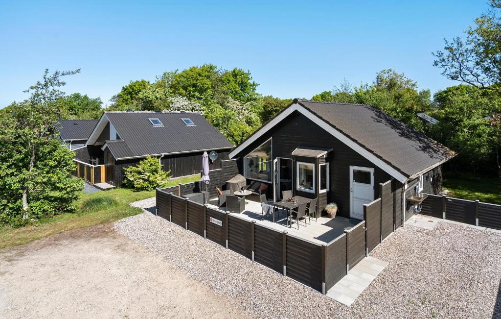 a black house with a fence in front of it at Pet Friendly Home In Hemmet With Wifi in Hemmet