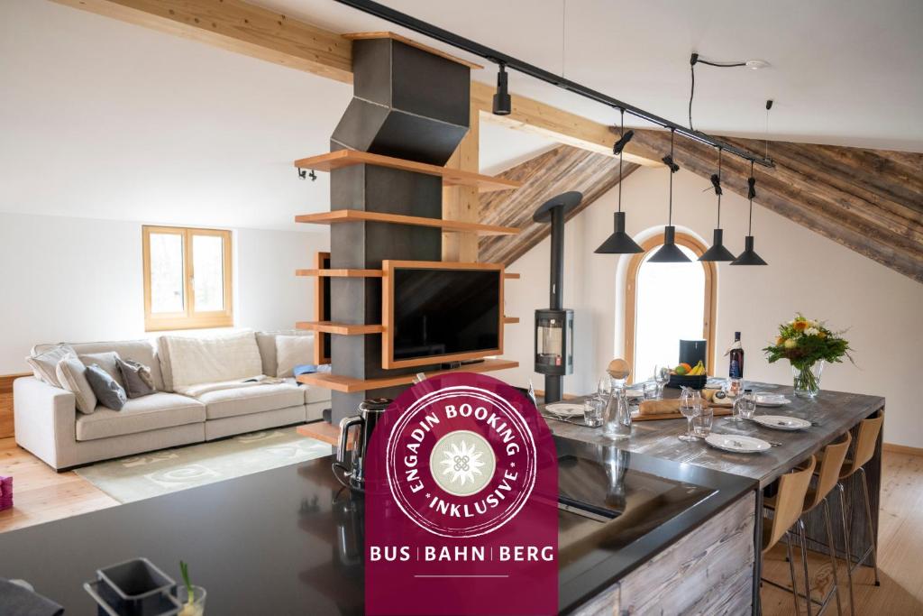 a bar in a living room with a bus brain beer sign at Chasa Bao in Sent