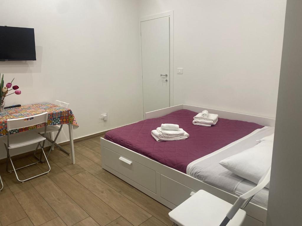 a bedroom with a bed and a desk and a mirror at Il Tulipano house in Catania