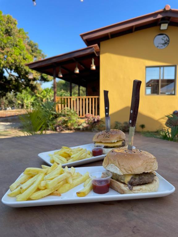 a plate with a hamburger and french fries on a table at Baruch Tropical Ranch in Los Santos