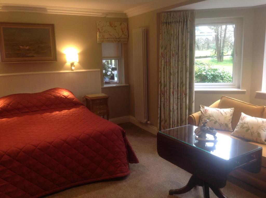 una camera d'albergo con un letto e una finestra di Gleann Fia Country House a Killarney