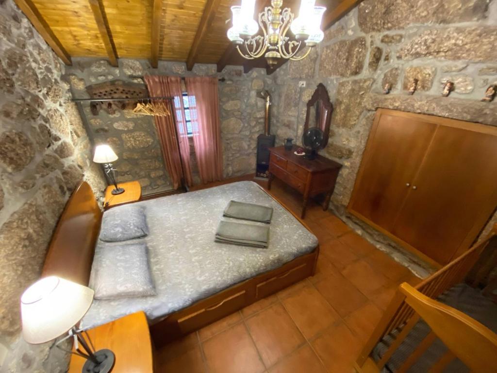 an overhead view of a bedroom in a stone house at Refúgio Rural no Gerês - Casa Araujo de Sousa in Terras de Bouro