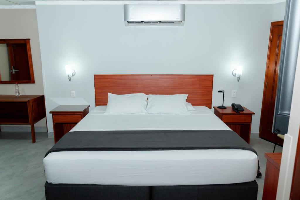 Postel nebo postele na pokoji v ubytování Grand Hotel Machala