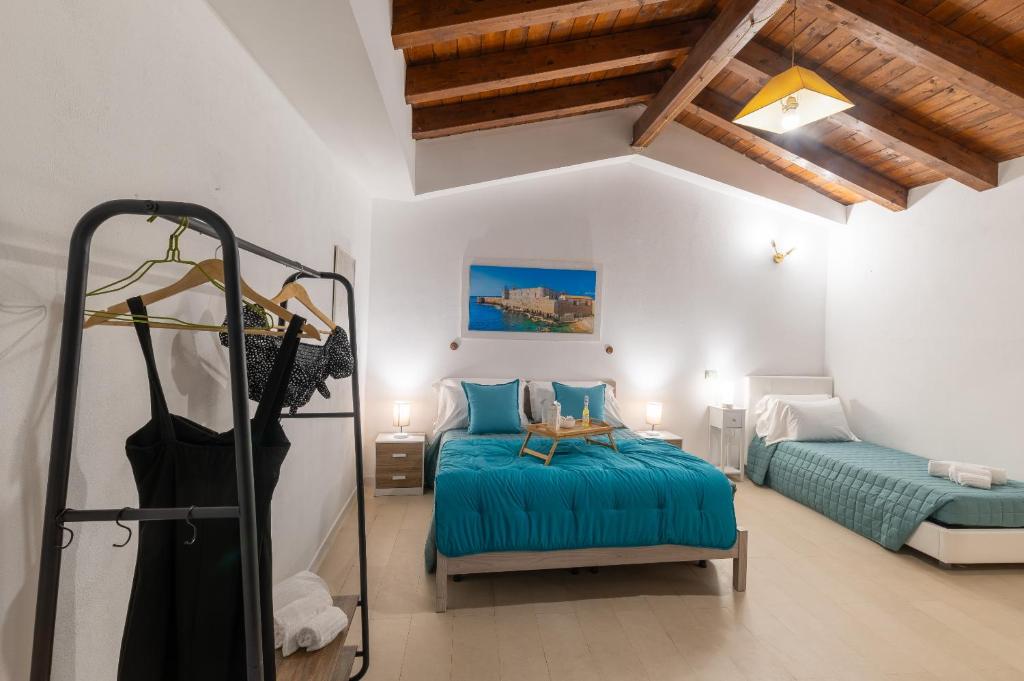 Postel nebo postele na pokoji v ubytování Elsa d'Ortigia - I TRE ARCHI