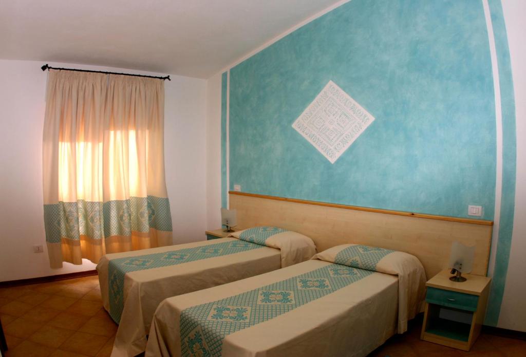 Postel nebo postele na pokoji v ubytování Hotel Petri Marini