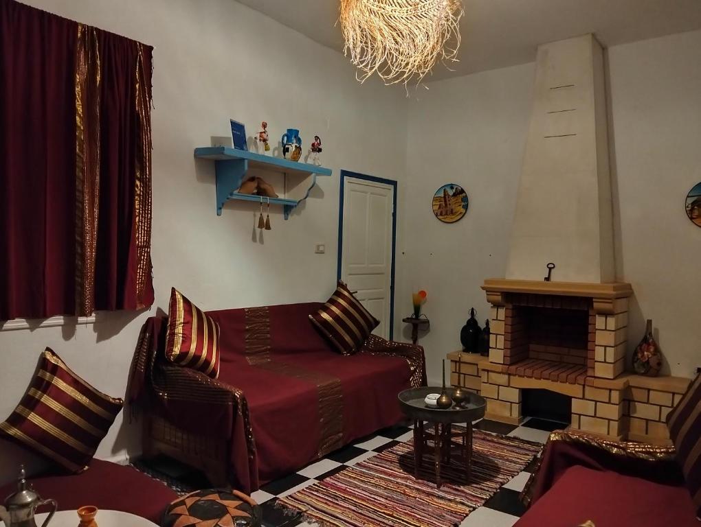 a living room with a couch and a fireplace at Henchir ejdoud in Kairouan