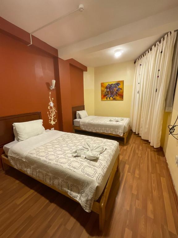 Postel nebo postele na pokoji v ubytování Hotel Andean Host Inn