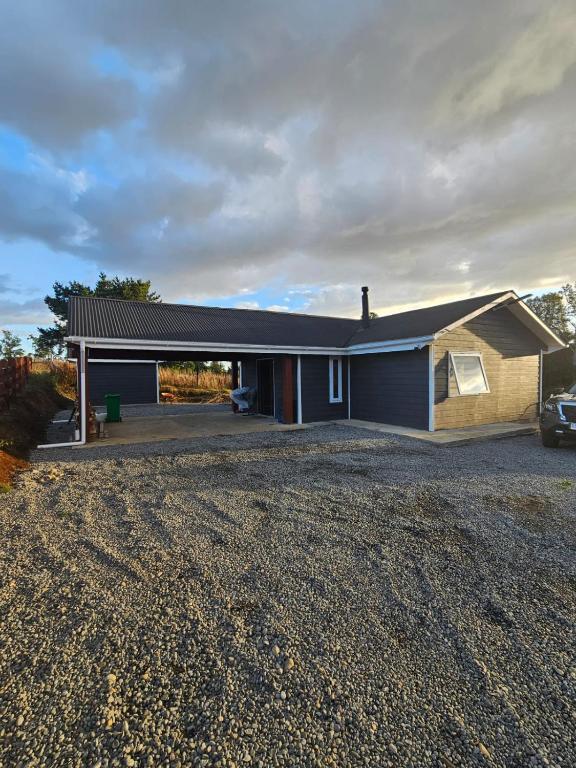 a house with a car parked in front of it at Casa Parcela, Bosques de Frutillar in Frutillar