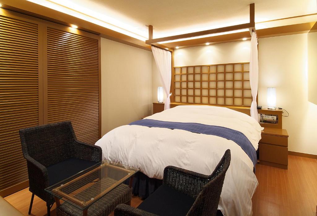 Postel nebo postele na pokoji v ubytování hotelLUANA 18歳未満入場禁止