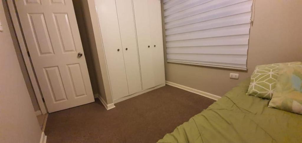 a small bedroom with a bed and a closet at Casa TREKKING TOUR ESTANCIA EL SAUCE COQUIMBO in Coquimbo