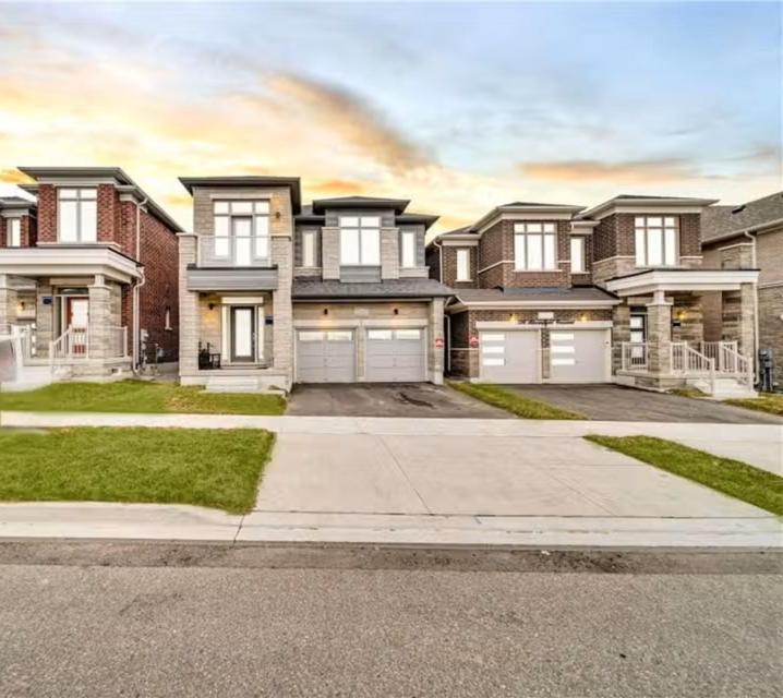 a large brick house with two garages at Cambridge Luxury by Ravine in Cambridge