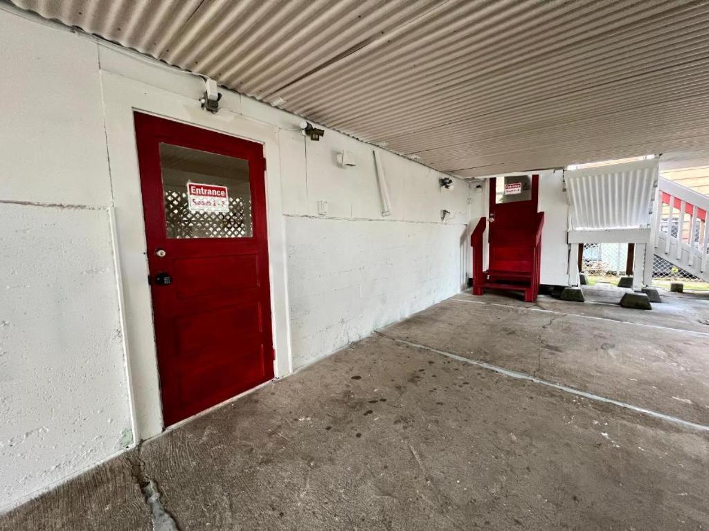 a building with a red door and a white chair at Furnished Private Room with Shared Bathroom near SeaTac Airport in Seattle