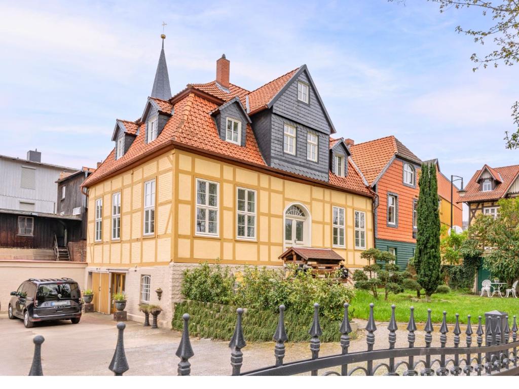 a large yellow house with a black roof at Harzträume No2 mit Parkplatz - Zentrum - Brockenbahn - 2 SZ in Wernigerode