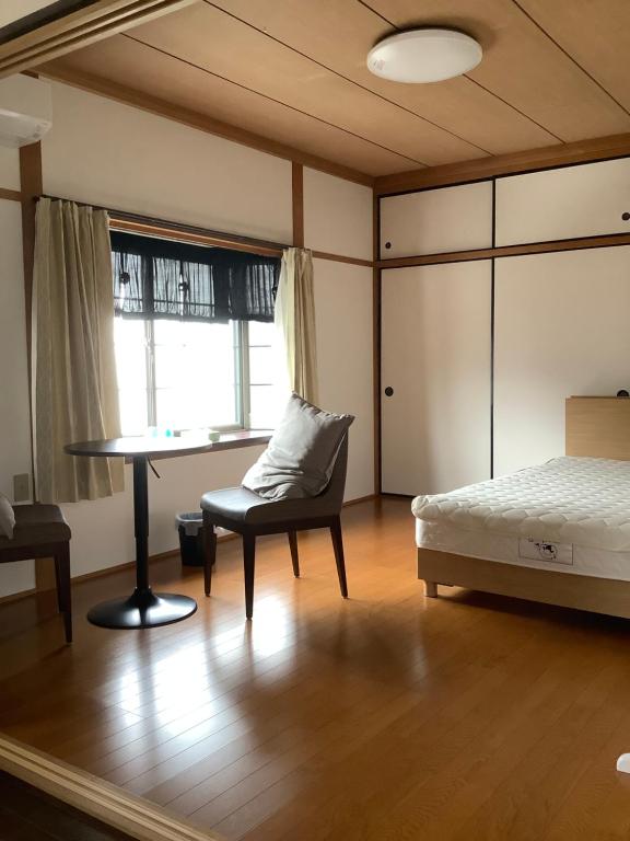 Postel nebo postele na pokoji v ubytování 民泊　筑紫野