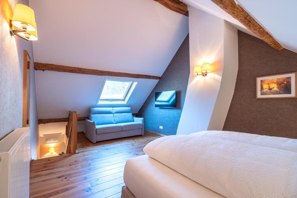 Postel nebo postele na pokoji v ubytování Le Vieux Moulin Weywertz