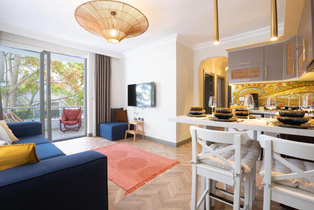 a kitchen and living room with a blue couch at Antalya NO:6 Luxury Comfort Art House in Antalya