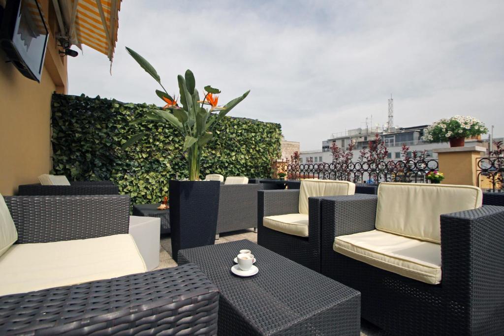 a group of chairs and tables on a balcony at Hotel Indipendenza in Rome