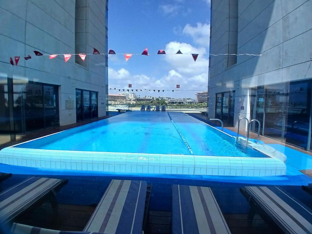 a large swimming pool in the middle of a building at מגדלי המרינה מלון דירות in Herzliya B