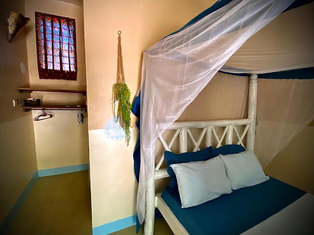 Postel nebo postele na pokoji v ubytování Darwesh Nyumba Lodge