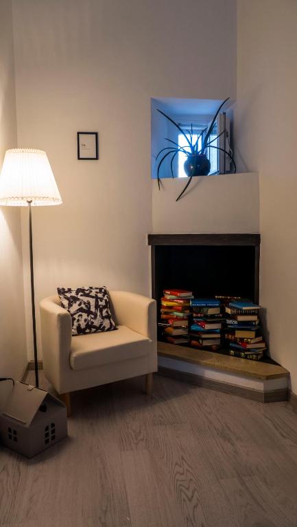 a living room with a chair and a fireplace at Domus 21 - DIEMME STAY in Alberobello