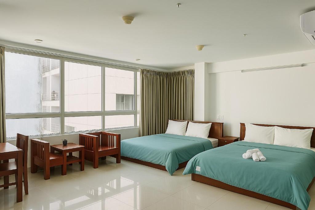 Postel nebo postele na pokoji v ubytování Onestar Danang Riverside