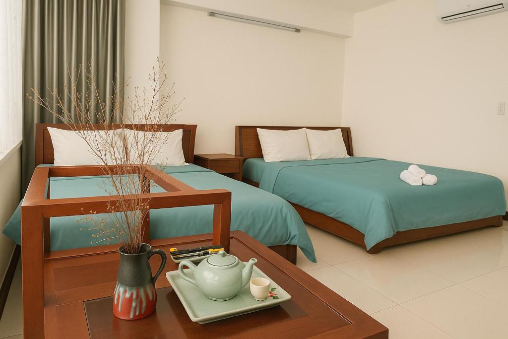 Postel nebo postele na pokoji v ubytování Onestar Danang Riverside