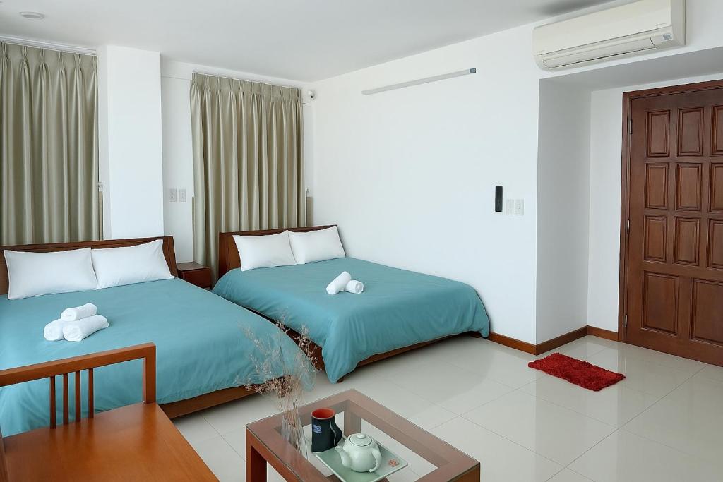 Postel nebo postele na pokoji v ubytování Onestar Danang Riverside