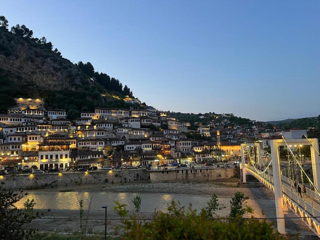 a town on a hill with a bridge over a river at Haxhialiu Villa in Berat