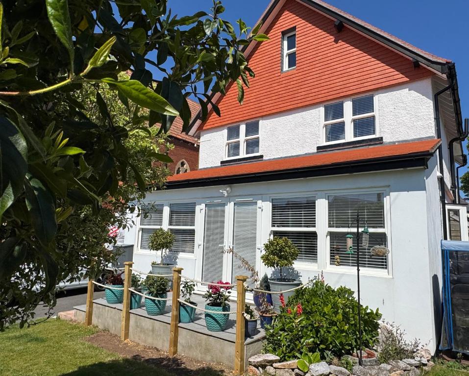 a white house with an orange roof at Raddenstile, Exmouth in Exmouth