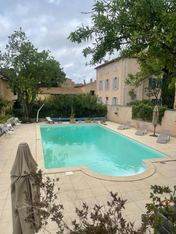 une piscine dans une cour avec un bâtiment dans l'établissement Montagne d'Alaric, à Moux