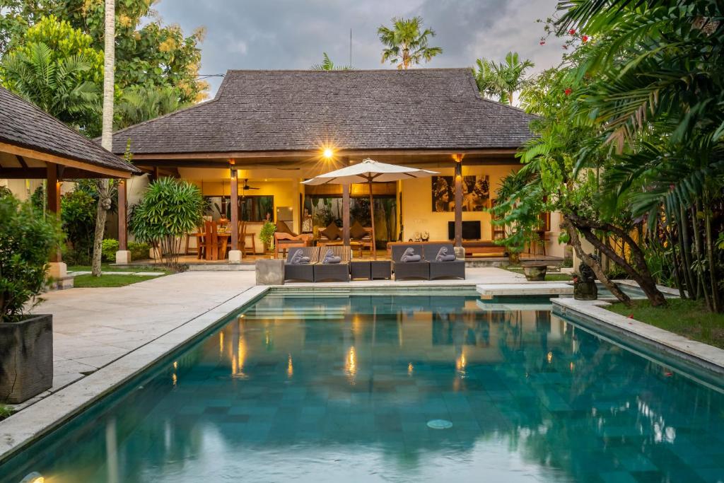 a swimming pool in front of a villa at Villa Alroda Antik - Peaceful 4BR Villa with Private Pool in Canggu in Dalung