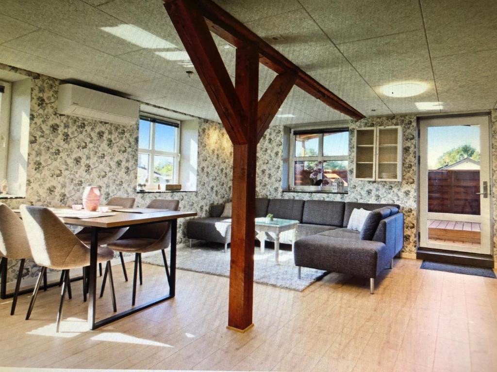 a living room with a table and chairs and a couch at Château de Sus in Løkken