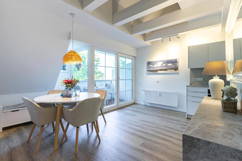 a kitchen and dining room with a table and chairs at Landhaus Butt 05 in Ahrenshoop