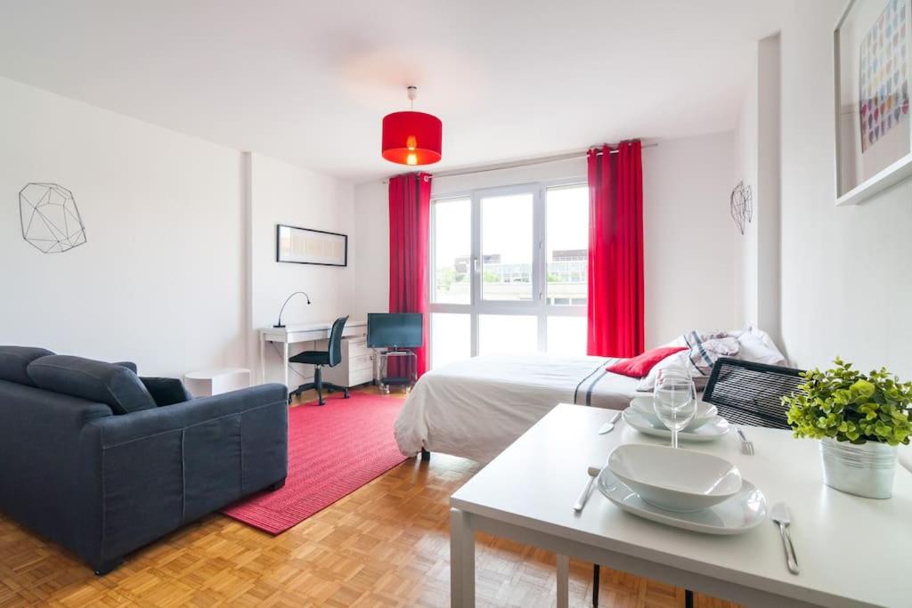 Cet appartement comprend une chambre avec un lit et un salon avec une table. dans l'établissement Studio lumineux Lyon, à Lyon