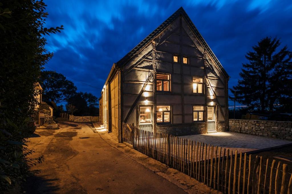 an old house with lights on the side of it at Gîte du Chapy in Beauraing