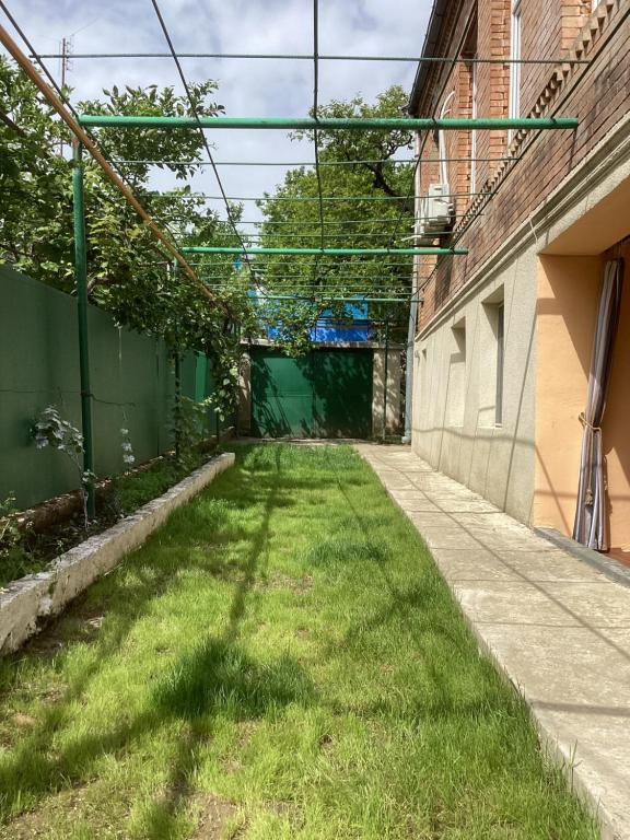 a grass alley with a tunnel in the background at B&B Villa Maurizio in Tsqaltubo