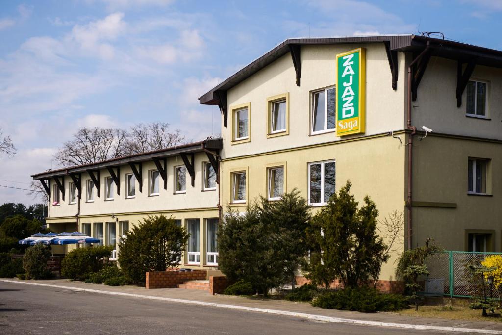 a building with a sign on the side of it at Zajazd Saga in Gryfino