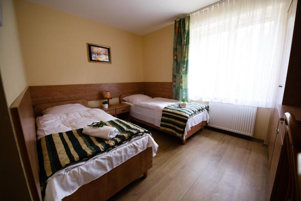 Postel nebo postele na pokoji v ubytování Zajazd Saga
