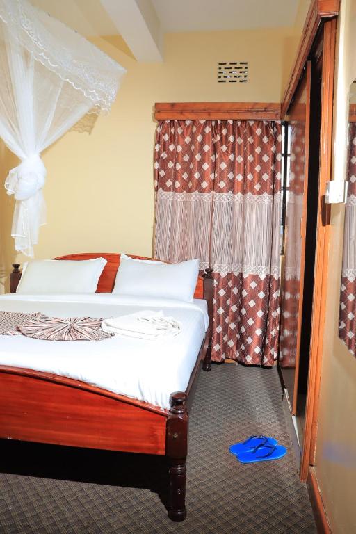 Postel nebo postele na pokoji v ubytování kapok city hotel