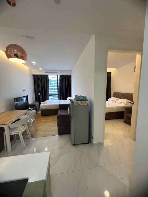 a living room and kitchen with a living room and a dining room at BORNEO Sutera Bay in Kota Kinabalu