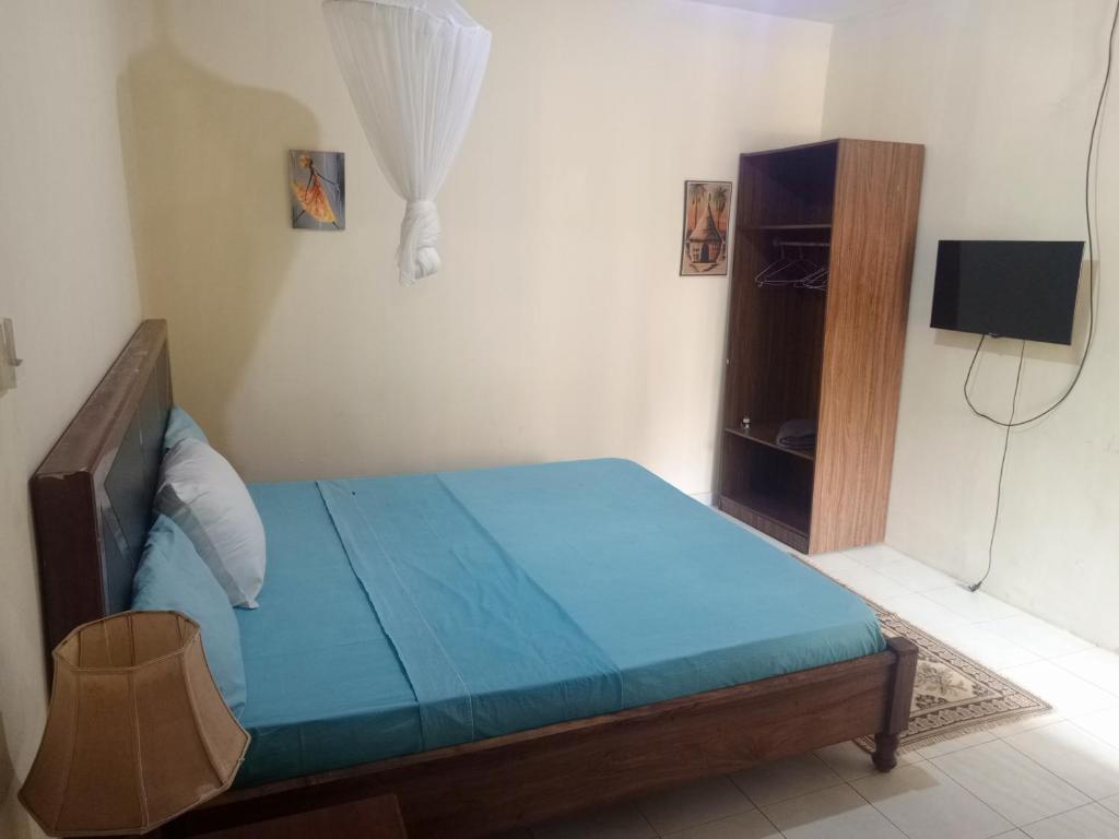 Postel nebo postele na pokoji v ubytování Casa Cacheu Homestay Guest House