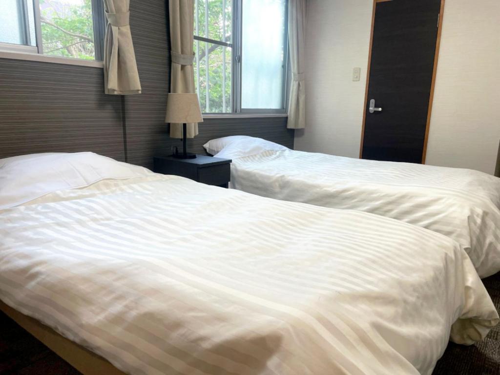 Postel nebo postele na pokoji v ubytování Itoen Hotel Inatori