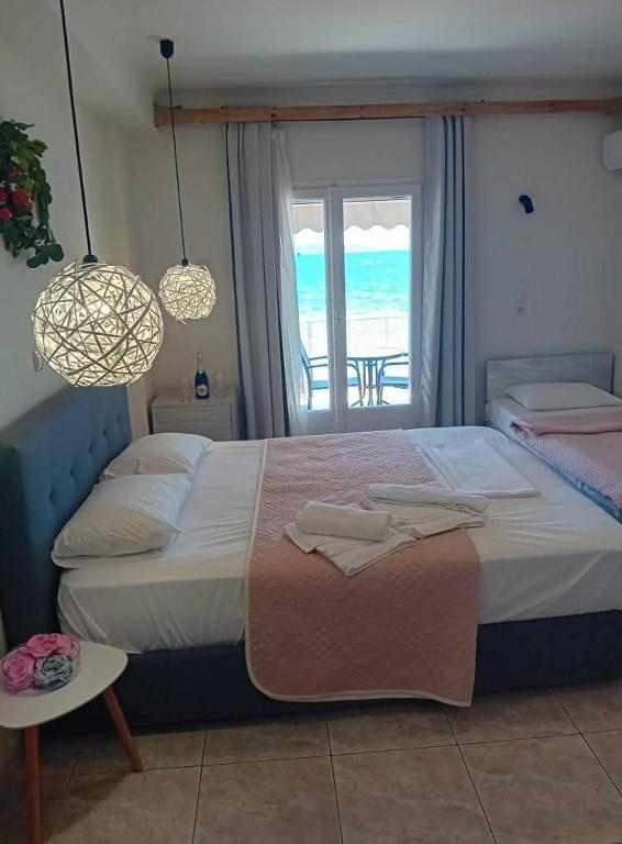 Postel nebo postele na pokoji v ubytování Hotel Assini Beach Tolo