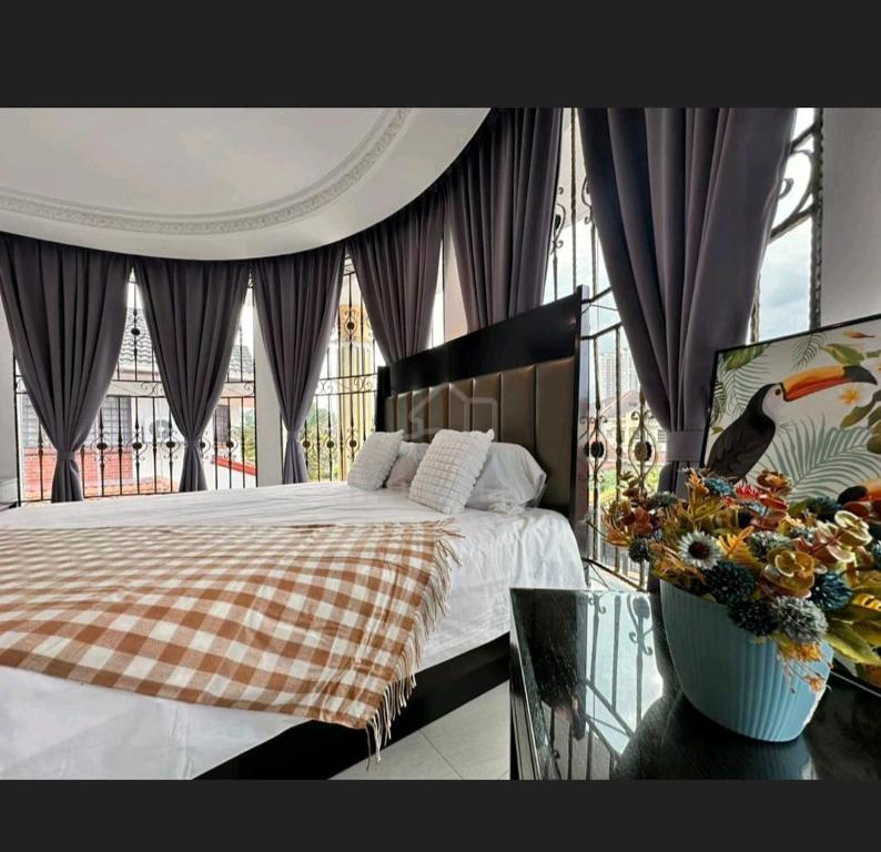a bedroom with a bed and a large window at EDS Senior Citizen Care Centre in Cheras