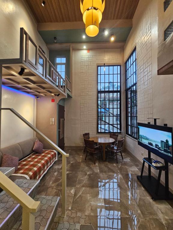 een woonkamer met een bank, een tv en een tafel bij Guillermo Residence in Malaybalay