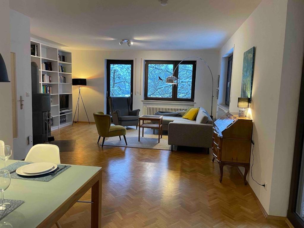 a living room with a couch and a table at Großzügige individuelle Wohnung am Starnberger See in Münsing am Starnberger See