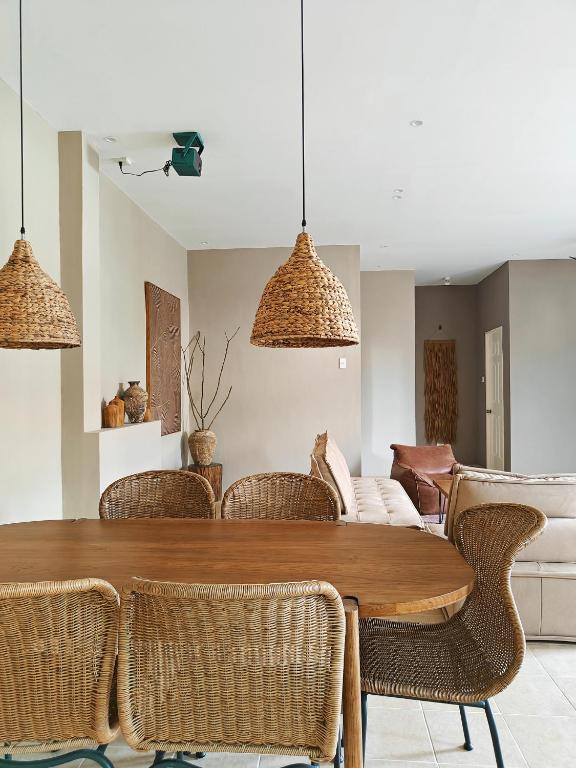 a dining room with a wooden table and chairs at The Palm House in Dauis