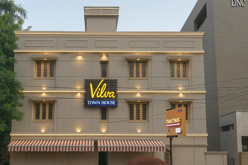 a building with a sign that reads villa town house at Vilva Town House in Chennai