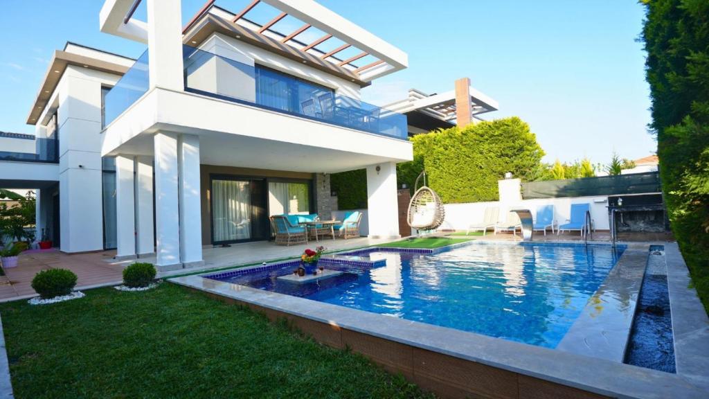 a house with a swimming pool in the yard at Çamyuva Lüks Villa in Agva